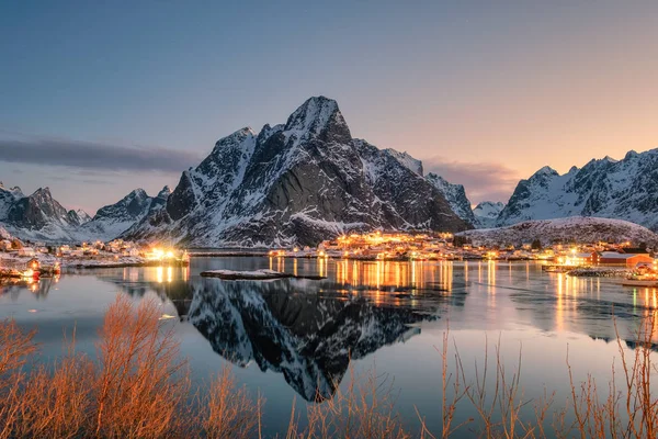 Fishing village illumination with mountain range  reflection on