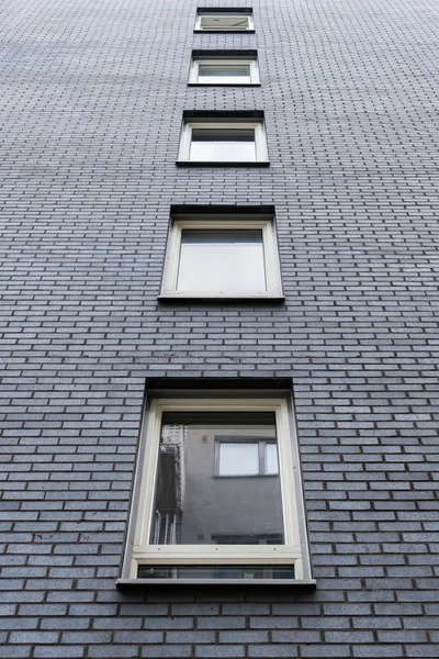 Windows on dark grey brick — Stock Photo, Image