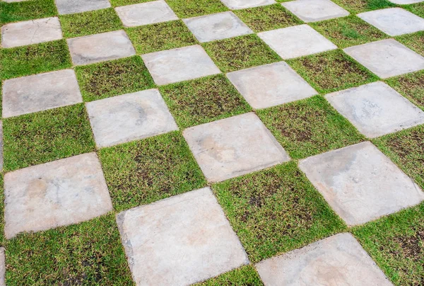 Chessboard stone with grass floor — Stock Photo, Image
