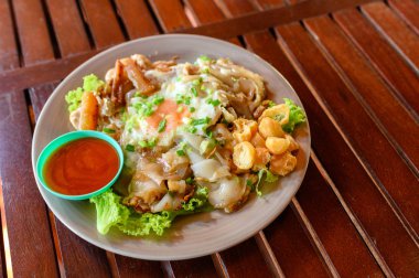 Tavuk, kalamar, kızarmış yumurta ve marul ile tavada pirinç şehriye