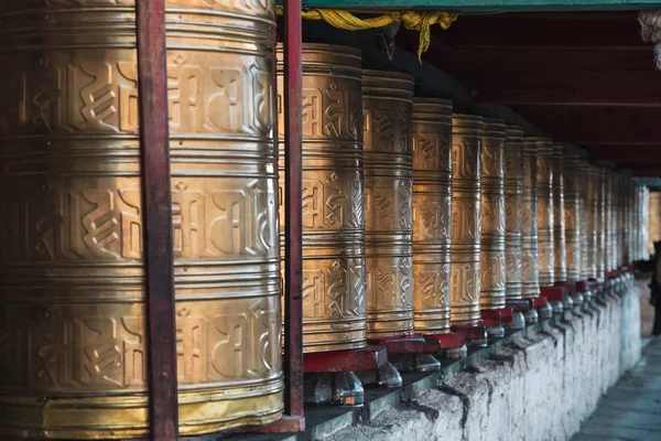 Tibet tapınağının eski geleneksel altın tekerlekleri sıraları — Stok fotoğraf