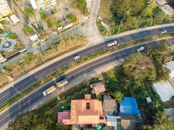 Aerial view of traffic on highway with building and nature in evening