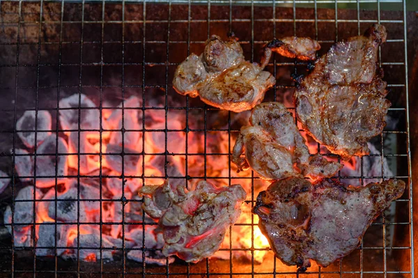 Grilled marinated pork on charcoal grill in dinner — Stock Photo, Image