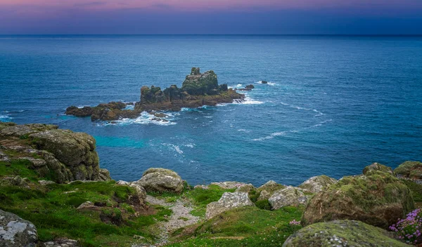 Sunset over the coast  in the Lands End - the most westerly point of England which is a popular tourist attraction, Penwith peninsula, Penzance, Cornwall