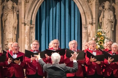 Rochester, England -  July 2018 : Mens choir performing in a cathedral, Kent, UK clipart