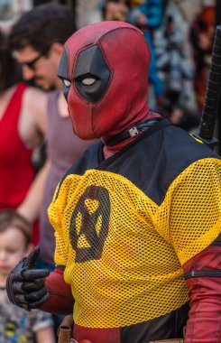 Rochester, England -  July 2018 : Man dressed as Deadpool character in costume promoting comic shop clipart