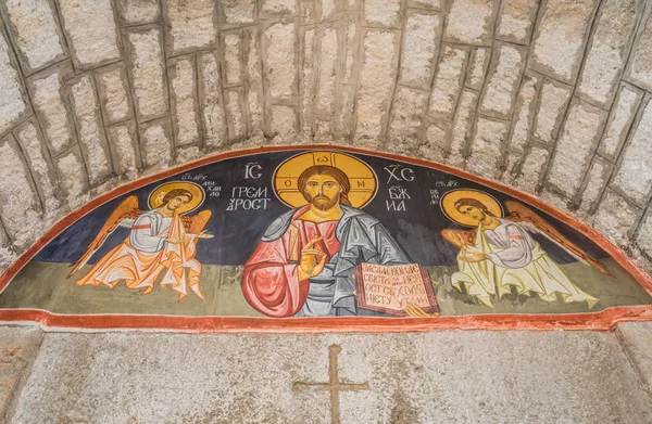 Old religious painting depicting Jesus Christ and angels painting on the wall of a monastery in Montenegro