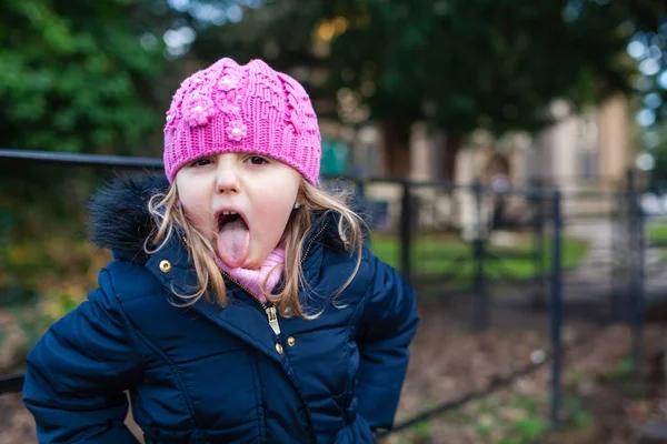Cute Naughty Caucasian Girl Wearing Pink Hat Sticking Her Tongue — Stock Photo, Image