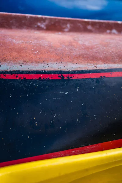 Close up of the colorful side decks of the small fishing boats on the shore in Perast town, Kotor Bay, Montenegro