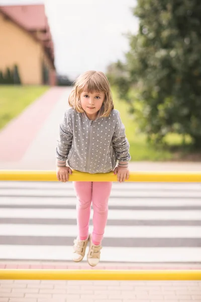 Cute Little Caucasian Girl Lifting Herself Exercising Yellow Street Barrier — Stock Photo, Image