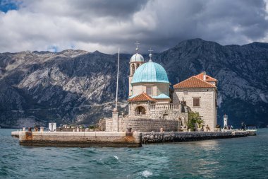 Perast, Montenegro - April 2018 : Our Lady on the Rocks and small Church on San George`s island in Kotor Bay clipart
