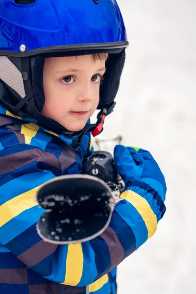 Portret van een jongetje dat zijn ski's vasthoudt — Stockfoto