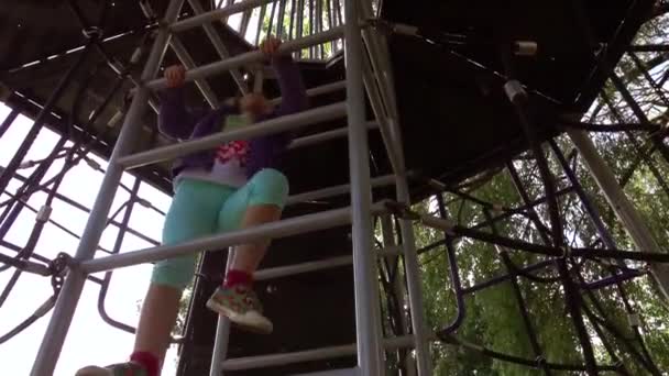 Little Young Caucasian Girl Climbing Ladder Cabin Spaceship Big Outdoor — Stock Video