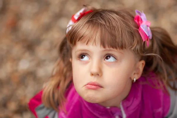 Grumpy little girl making faces — Stock Photo, Image
