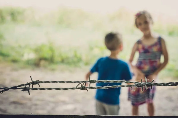Kids behind berbed wire — Stock Photo, Image