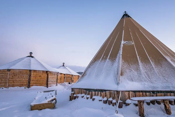 Wooden huts and canvas tent