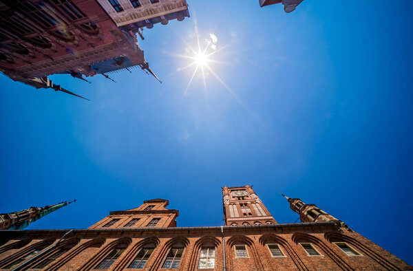 A low angle shot of the Clock Tower of Ratusz building in Torun, Poland