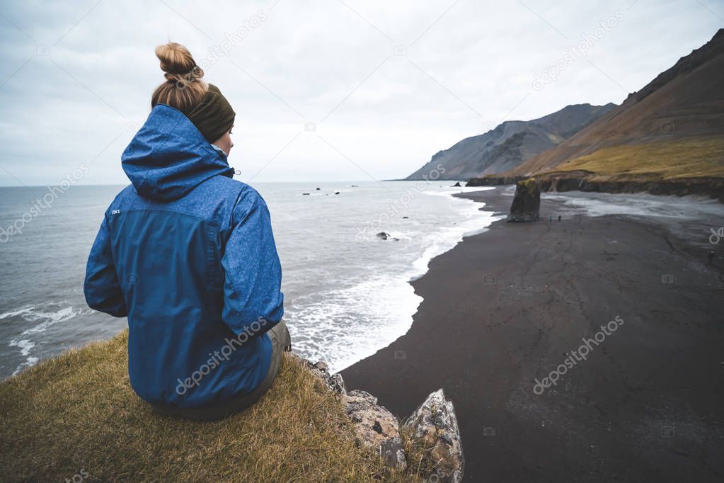 young woman looking at majestic icelandic landscape
