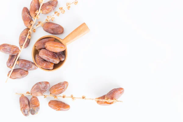 Dates fruit in wooden ladle on white background,Dried date palm fruits top view