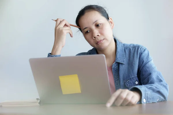 Asian women are thinking at office, Woman are stressed with work