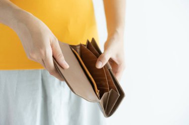 Woman hand open empty brown leather wallet , no money in pocket on white background