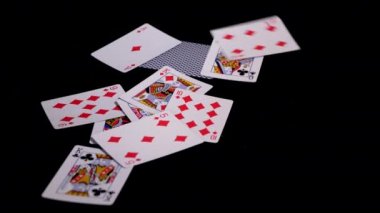 Poker kartları sinek ve siyah bir yüzeye düşmek.