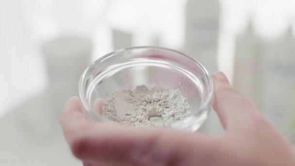 Womens hands stir cosmetic mask in a bowl. Close-up. — Stock Video