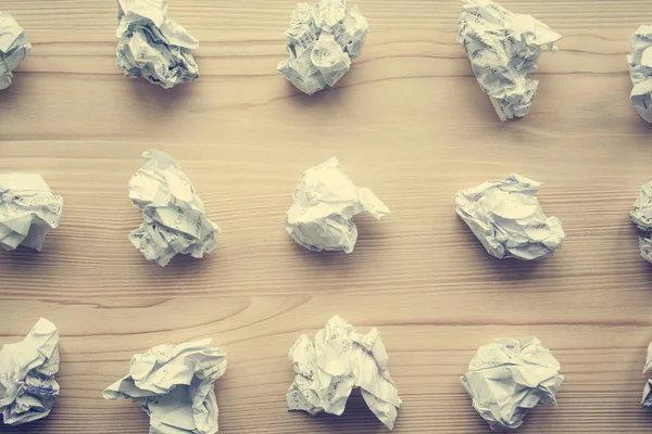 Many crumpled white paper balls from above background. Texture of crumpled paper balls.  Crumpled paper as brainstorming, creativity concept, mistakes and creation symbol. toned