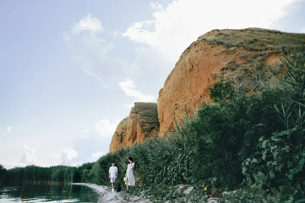 Outdoor portrait of young pregnant couple are walking lake view — Stock Photo, Image