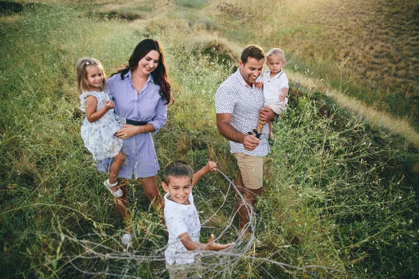 Happy parents and children having fun outdoors in a wheat field. up view — Stock Photo, Image