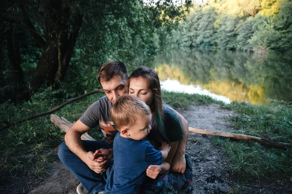 Family together on the bank of the river — Stock Photo, Image