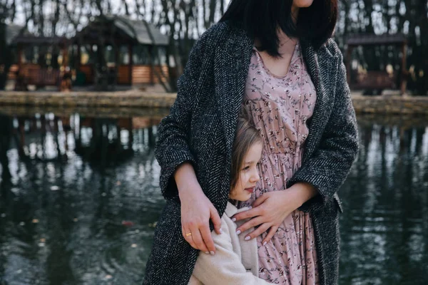 Mutter und seine Tochter spielen und umarmen sich im Freien — Stockfoto