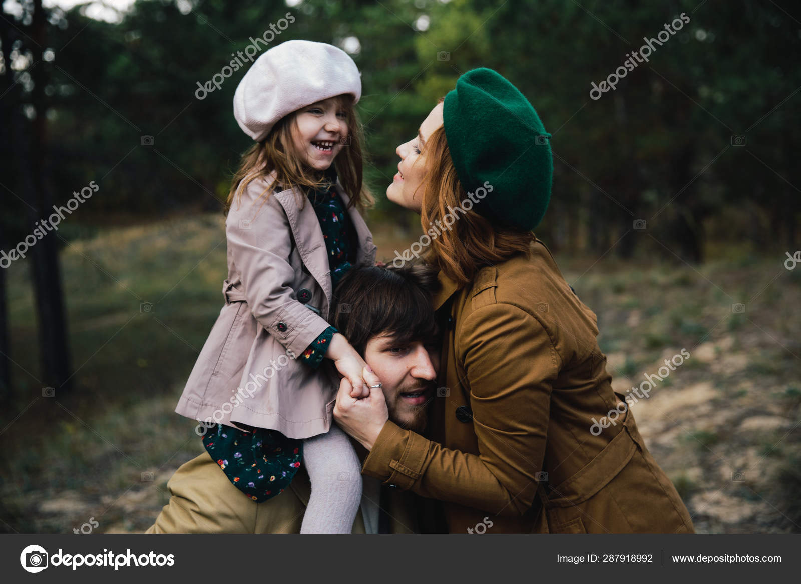 Young father, mother and little toddler daughter girl in a beret ...