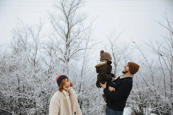 Happy family having fun on the snow trees background. — Stock Photo, Image