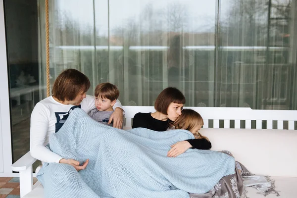 Lycklig familj ha kul på en swing rida på en trädgård en sommardag — Stockfoto