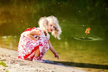 güzel kıvırcık kız nehirde suya yakın oynamaktan