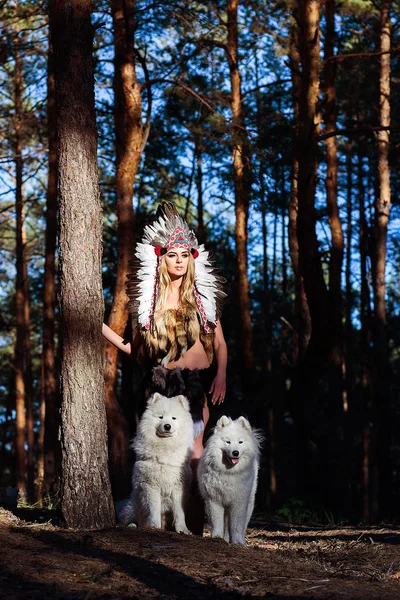 girl with a dog is hunting in the forest like an indian