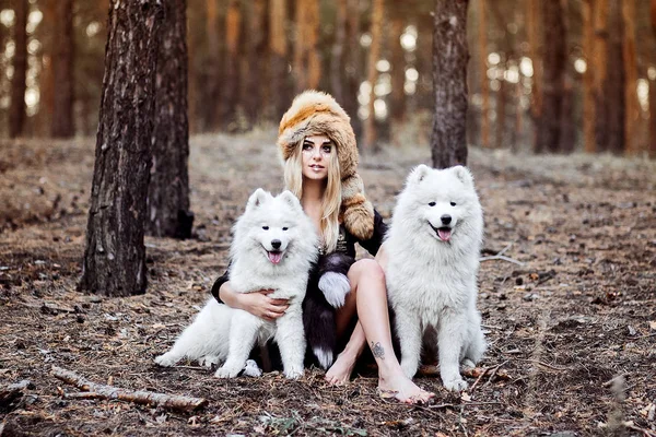 girl with a dog is hunting in the forest like an indian