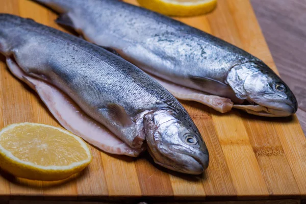 trout lies on a cutting board for dinner