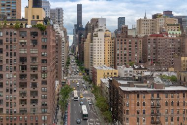 Roosevelt Adası Tramvayı 'ndan New York manzaralı. Gündüz vakti sokakta sarı taksi ve otobüs.