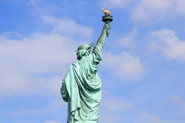 The Statue of Liberty on Liberty Island in New York City. It is the copper statue which is a gift from the people of France to the United States. She holds a torch above her head.