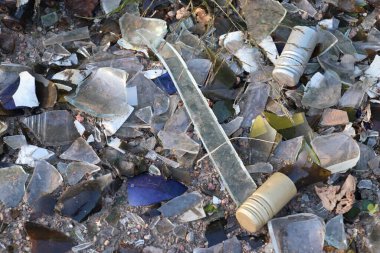 Pile of broken glass and bottle fragments on the ground  symbol of danger, environmental pollution, and the consequences of human activity