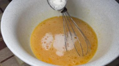 Baking process: eggs mixed with sugar, adding baking soda quenched with vinegar  culinary footage for recipes, blogs, food product ads, and educational content