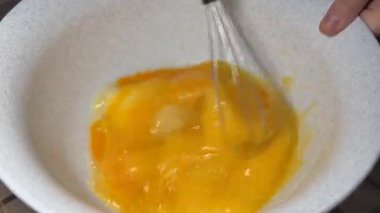 Whisking eggs and sugar in a bowl  pancake batter preparation step, perfect for culinary content, recipe videos, ingredient ads, and educational clips
