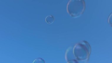 Soap bubbles against blue sky  lightness, joy, and childhood carefree mood for advertising, festive projects, backgrounds, wellness content, and summer campaigns