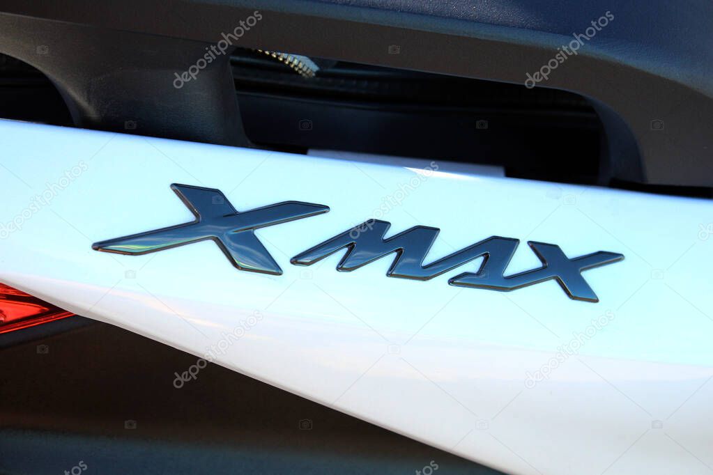 Vinnytsia, Ukraine; September 06, 2025. Close-up of Yamaha Xmax badge in glossy black finish on white surface of Yamaha scooter. Letters are stylized and reflect light with metallic sheen.