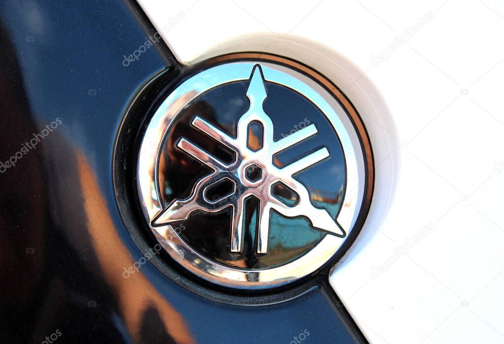 Vinnytsia, Ukraine; September 06, 2025. Close up black Yamaha logo. Close-up of glossy black and chrome Yamaha emblem. Yamaha Motor Company logo and emblem. Emblem features intersecting tuning forks.