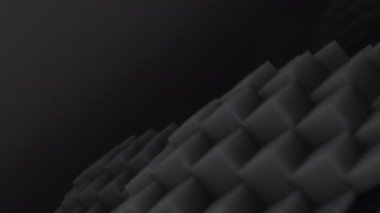 3D şekiller kusursuz bir video gibi hareket ediyor. Karanlık, pürüzsüz, hareketsiz karelerin arka planı. Küpler yukarı aşağı hareket eder ve büyüleyici bir zemin oluşturur. Parlak renk ve pürüzsüz animasyon 3D sanat. 4K Çözünürlüğü