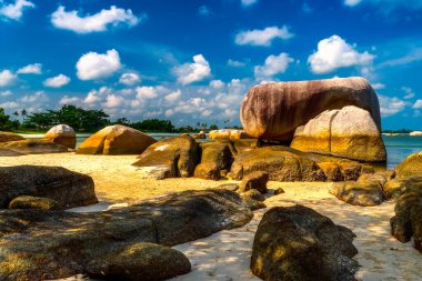 Many large stones on Tanjung Tinggi beach from Belitung Island clipart