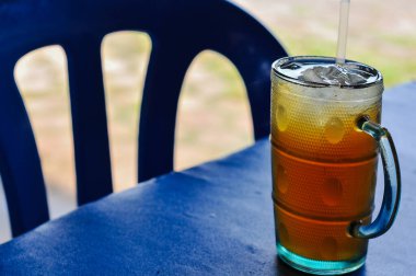 tea and lemon in glass on table